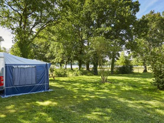 Forfait Privilège (tente, caravane ou camping-car / 1 voiture / électricité 16A). Grand emplacement avec vue sur lac